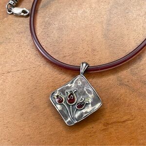 Handmaid’s sterling silver pendant on Garnet colored chain with garnet gemstone.